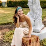 Woman with long hair happily wearing the most comfortable hand-made headband in the print Arwen Floral.
