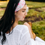 Woman with long hair happily wearing the most comfortable hand-made headband in the print Catnip & Clover.