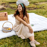 Woman with long hair happily wearing the most comfortable hand-made headband in the print Opal Floral.