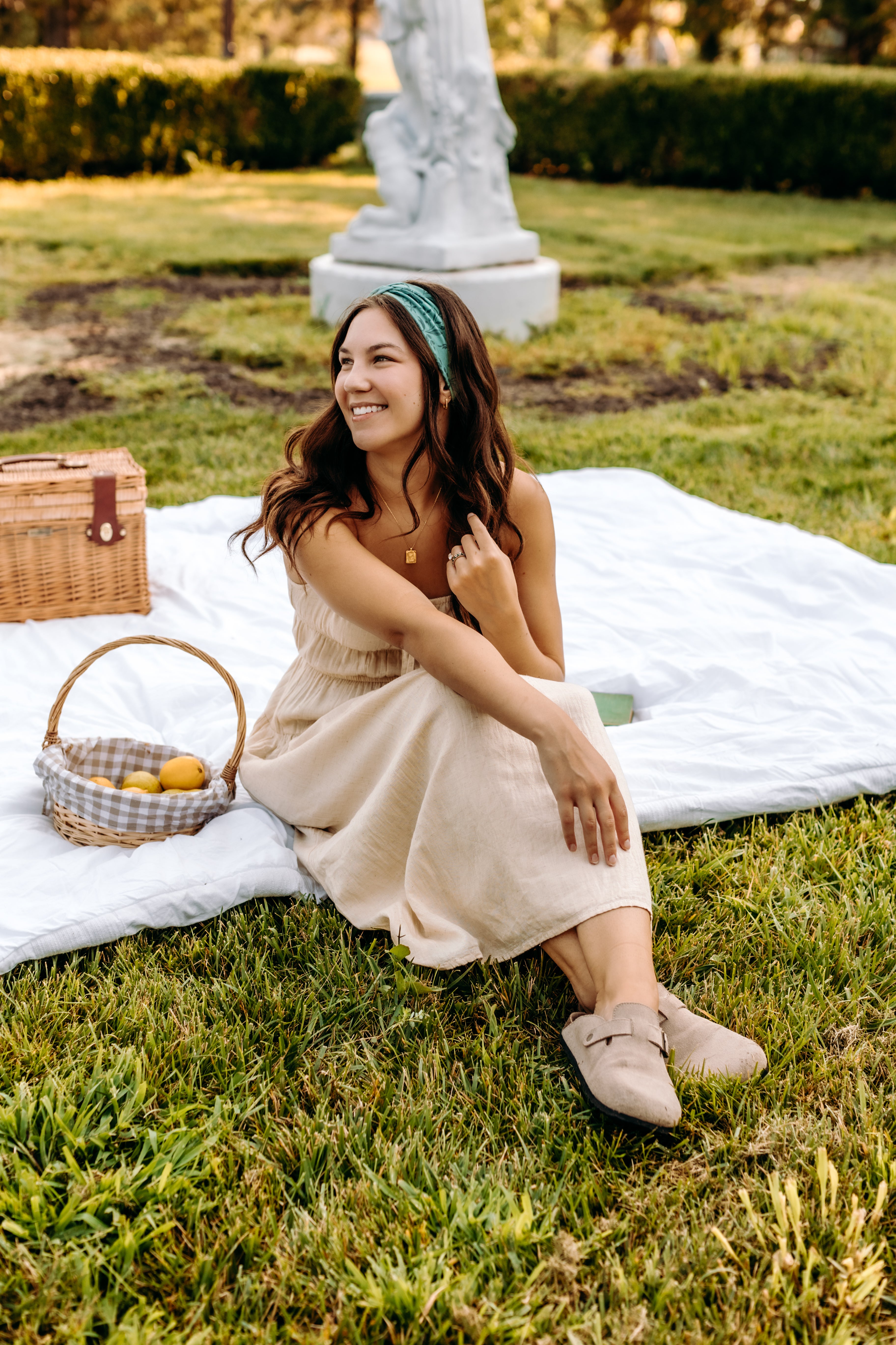 Woman with long hair happily wearing the most comfortable hand-made headband in the print Opal Floral.