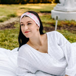 Woman with long hair happily wearing the most comfortable hand-made headband in the print Catnip & Clover.