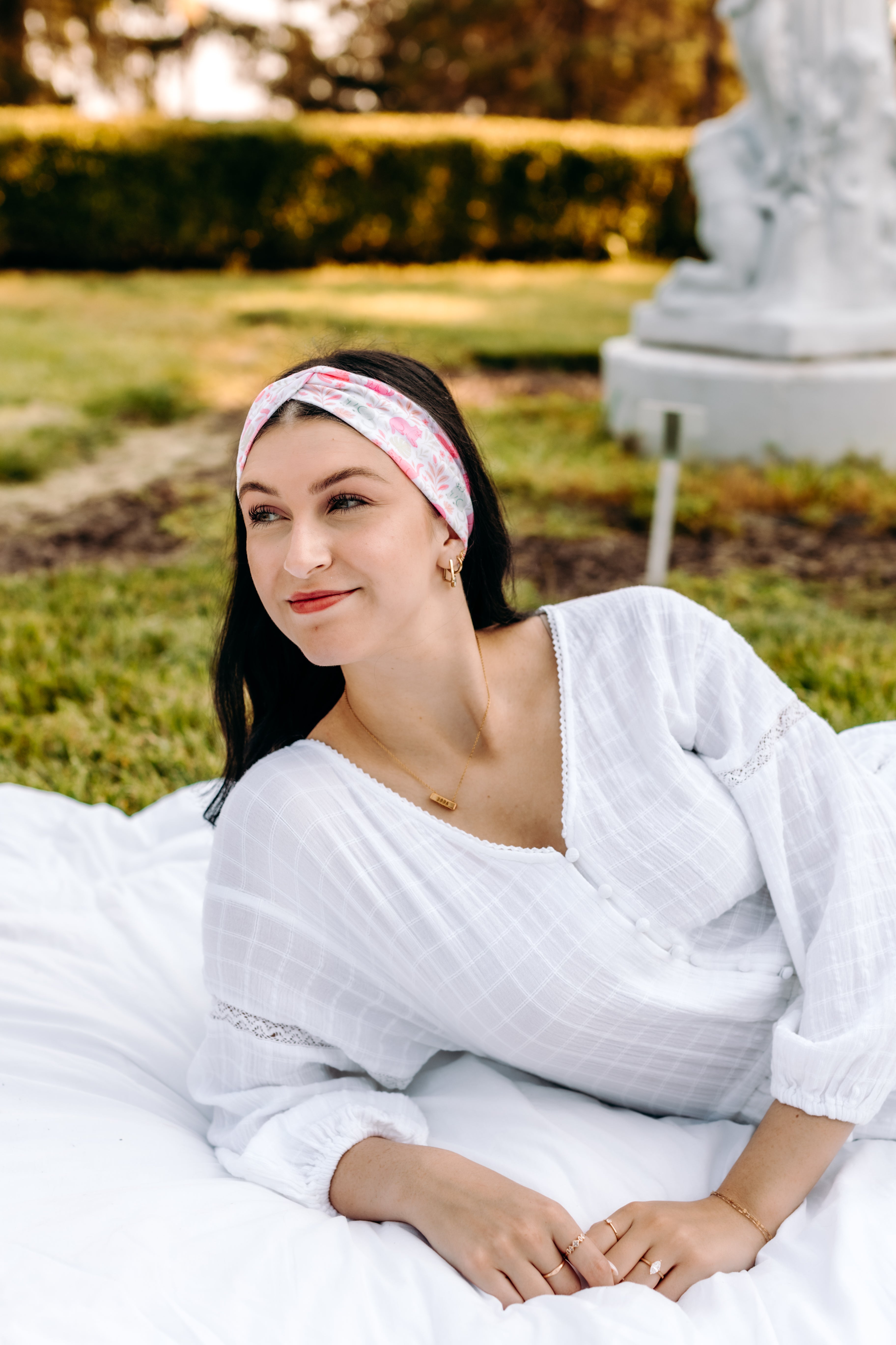 Woman with long hair happily wearing the most comfortable hand-made headband in the print Catnip & Clover.