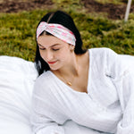 Woman with long hair happily wearing the most comfortable hand-made headband in the print Catnip & Clover.