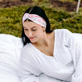 Woman with long hair happily wearing the most comfortable hand-made headband in the print Catnip & Clover.