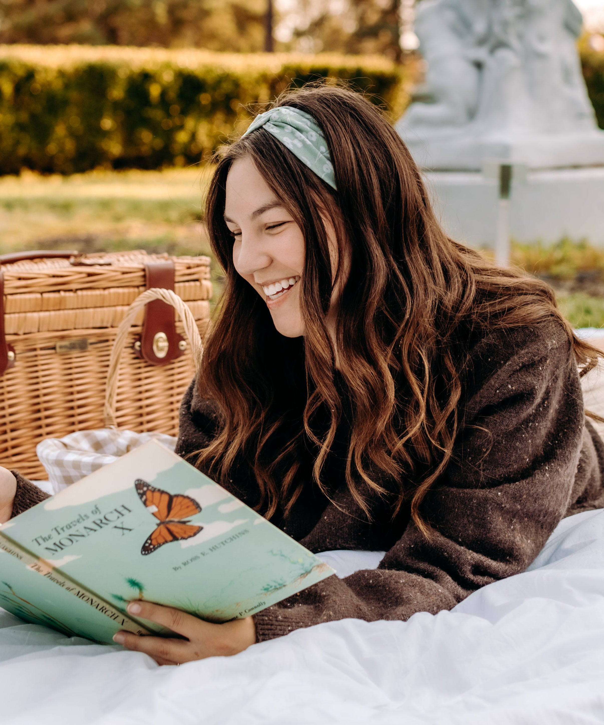 Woman with long hair happily wearing the most comfortable hand-made headband in the print Hazel Floral.