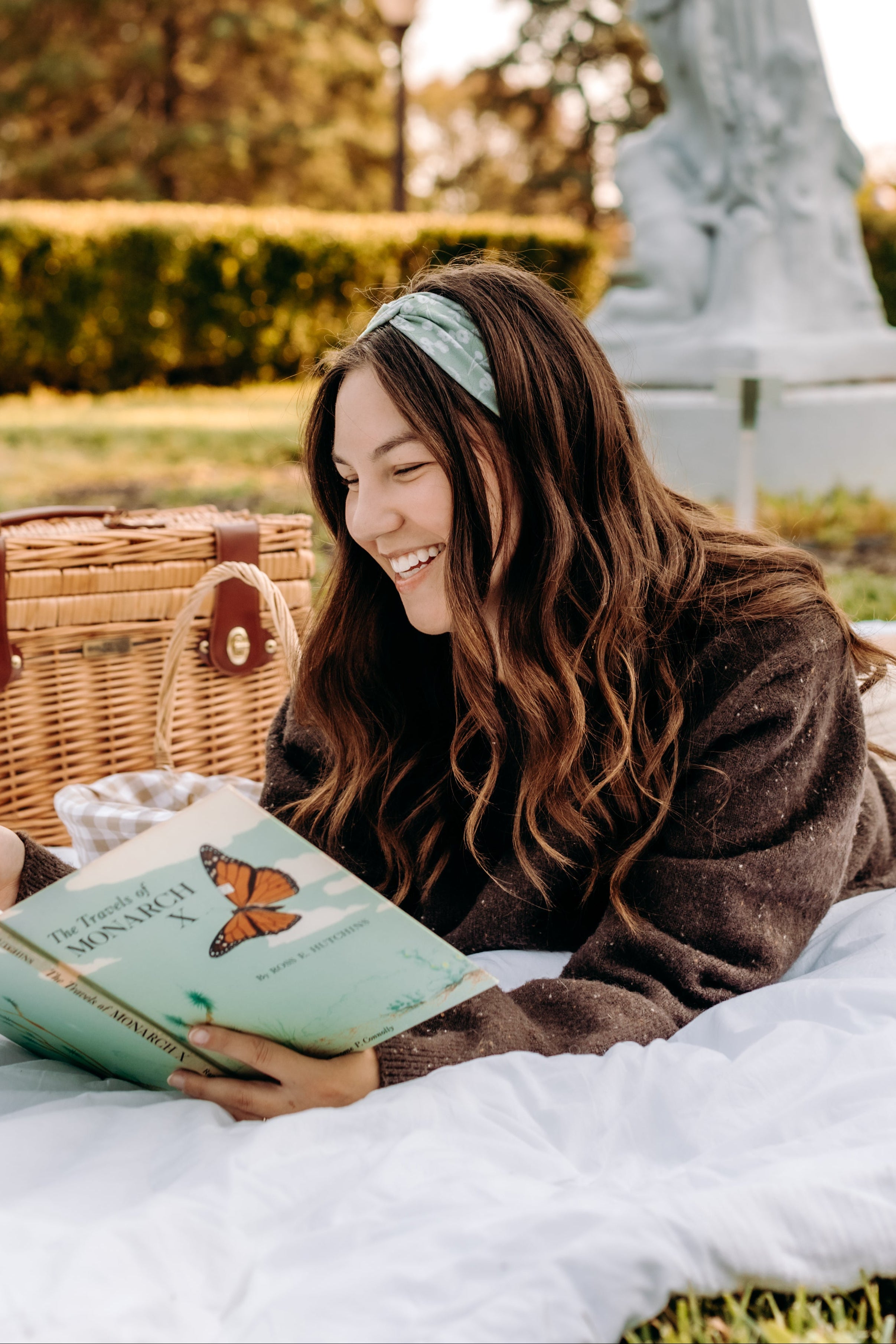 Woman with long hair happily wearing the most comfortable hand-made headband in the print Hazel Floral.