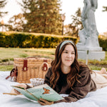 Woman with long hair happily wearing the most comfortable hand-made headband in the print Hazel Floral.