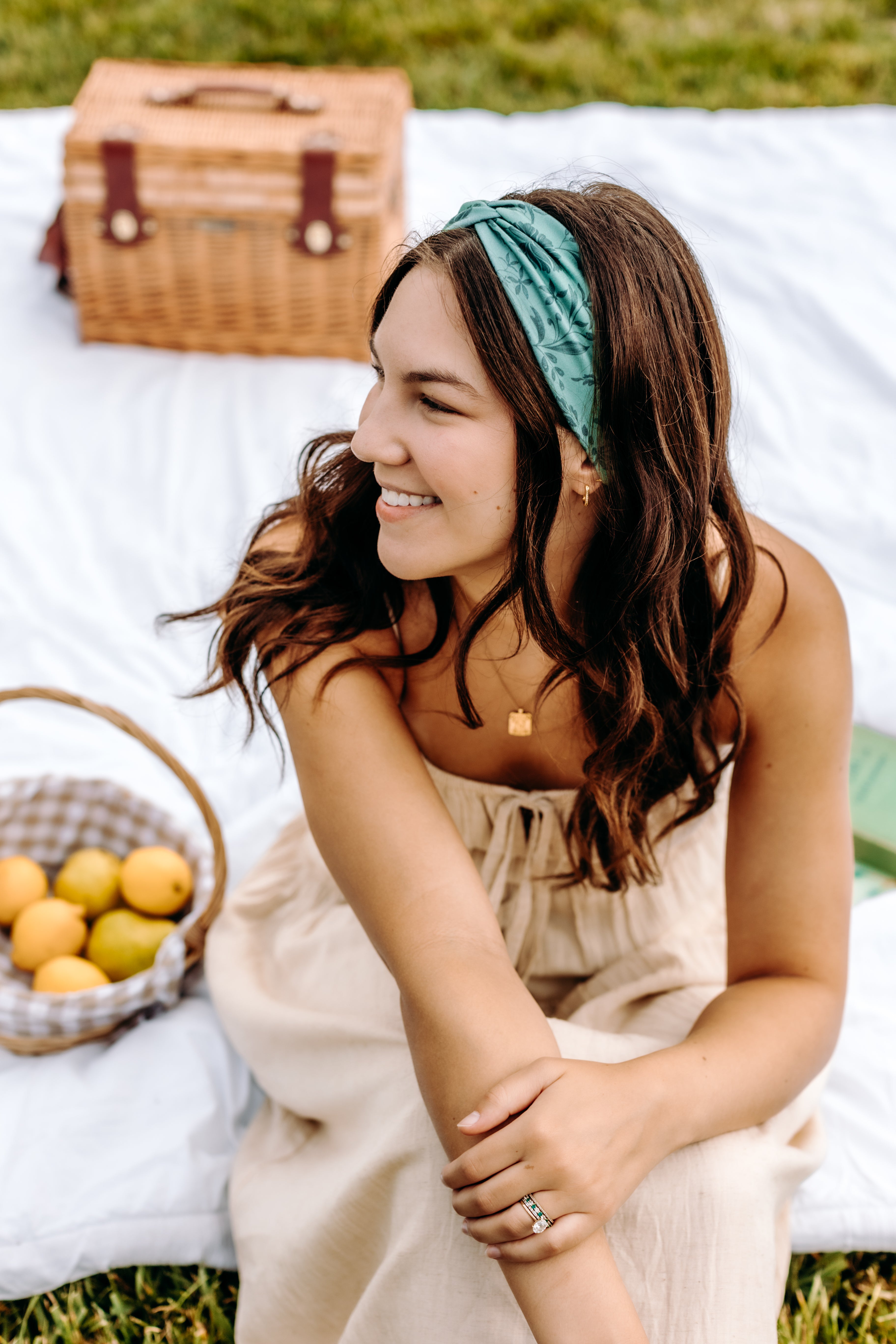 Woman with long hair happily wearing the most comfortable hand-made headband in the print Opal Floral.