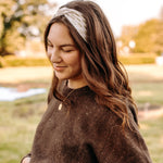 Woman with long hair happily wearing the most comfortable hand-made headband in the print Olive Patch. 