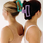 Two women wearing Vacation Vibes Lilac Clips with stylish hair, a fashion accessory perfect for all hair types. Matte material, 4.8 inches long, with a hinge closure.