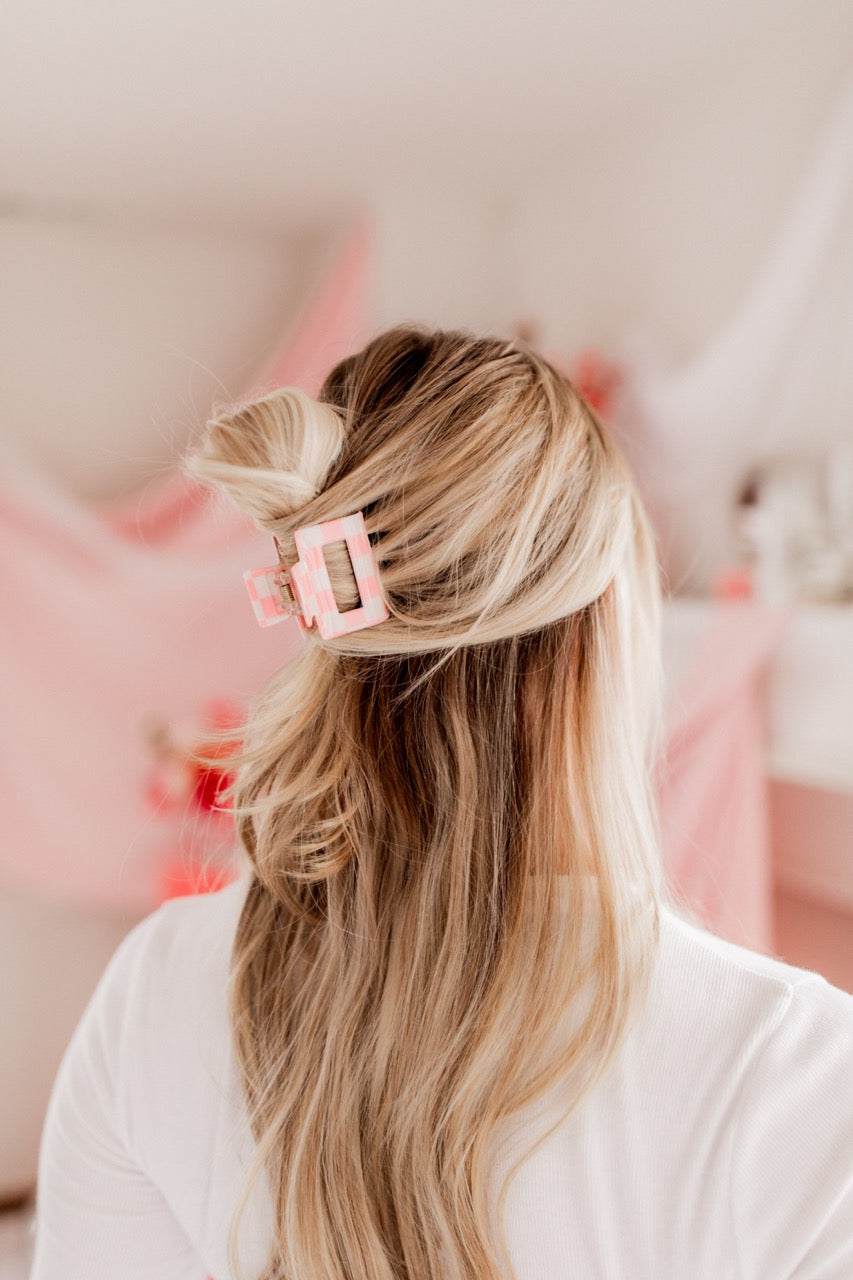 Checking In Lilac Clip: a 2-inch glossy checkered claw clip with a hinge closure, perfect for styling and keeping hair in place.