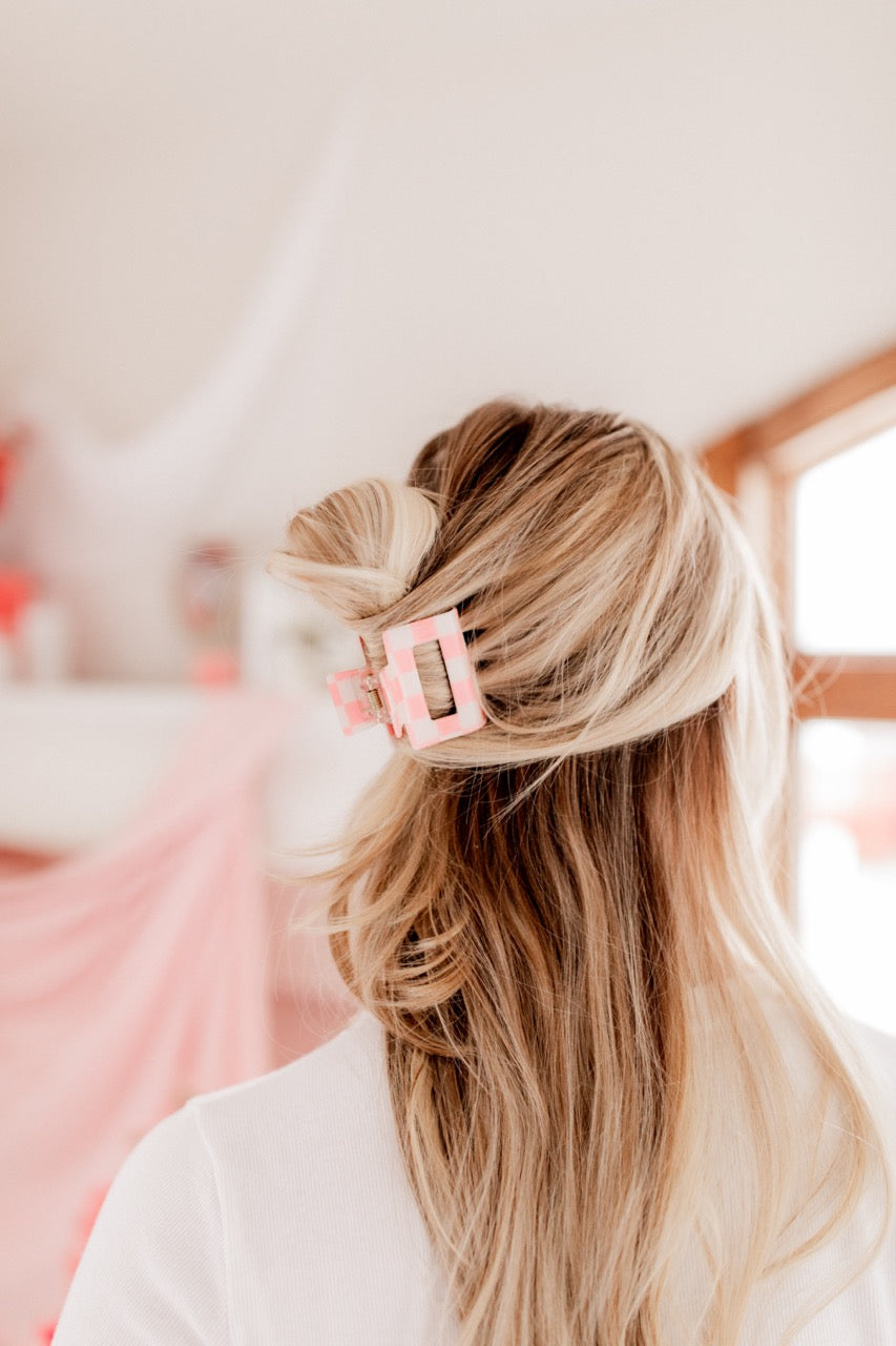 Checking In Lilac Clip: a 2-inch glossy checkered claw clip with a hinge closure, perfect for styling and keeping hair in place.