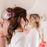 Checking In Lilac Clip: a 2-inch glossy checkered claw clip with a hinge closure, perfect for styling and keeping hair in place.