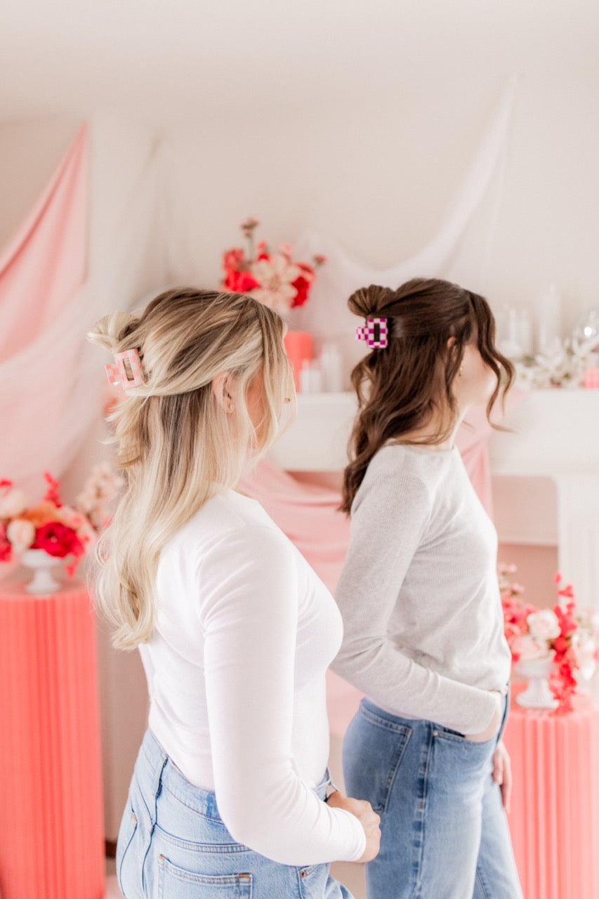 Checking In Lilac Clip: a 2-inch glossy checkered claw clip with a hinge closure, perfect for styling and keeping hair in place.