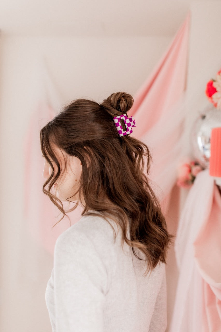 Checking In Lilac Clip: a 2-inch glossy checkered claw clip with a hinge closure, perfect for styling and keeping hair in place.