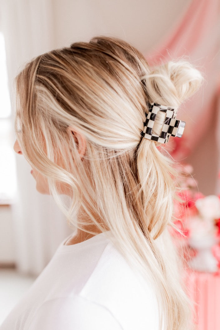 Checking In Lilac Clip: a 2-inch glossy checkered claw clip with a hinge closure, perfect for styling and keeping hair in place.