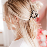 Checking In Lilac Clip: a 2-inch glossy checkered claw clip with a hinge closure, perfect for styling and keeping hair in place.