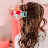 Checking In Lilac Clip: a 2-inch glossy checkered claw clip with a hinge closure, perfect for styling and keeping hair in place.