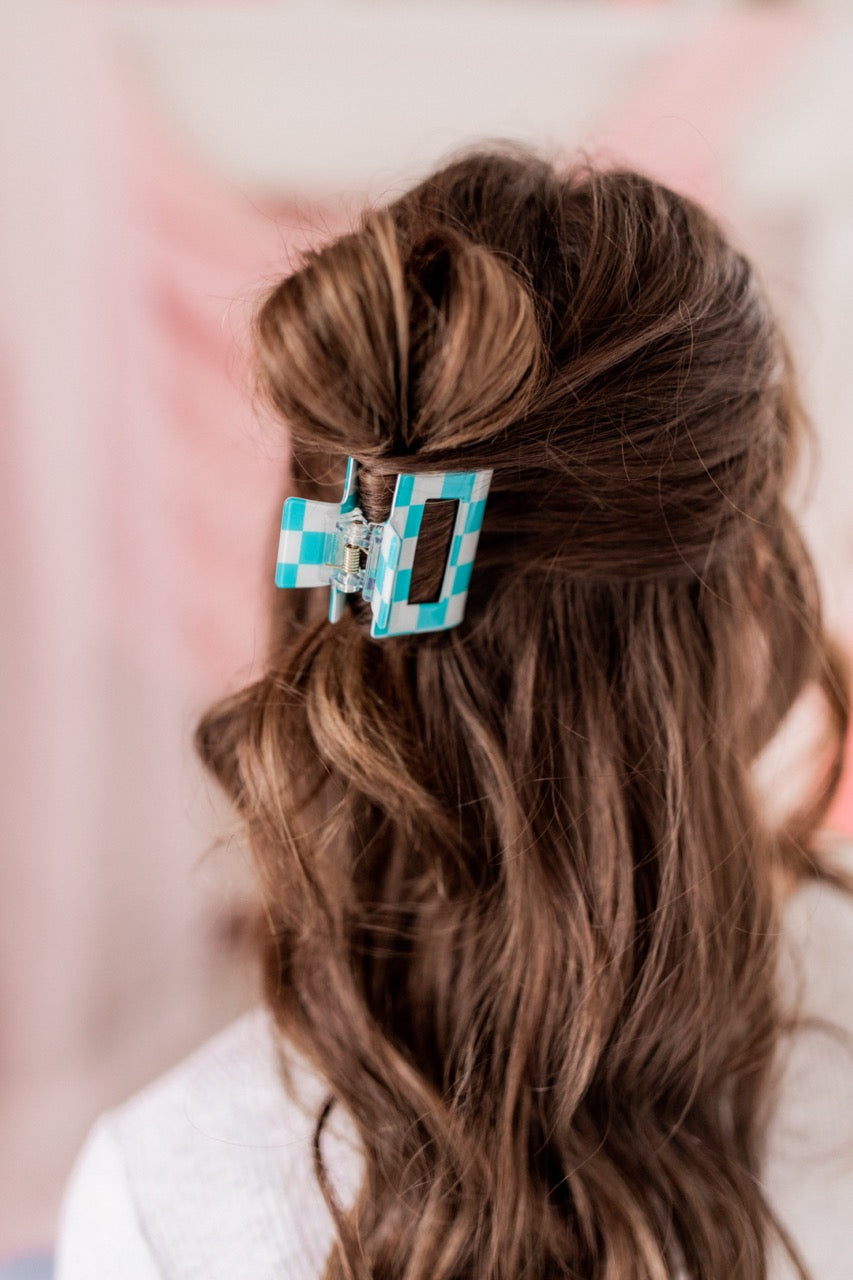 Checking In Lilac Clip: a 2-inch glossy checkered claw clip with a hinge closure, perfect for styling and keeping hair in place.