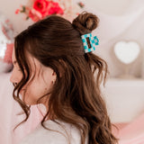 Checking In Lilac Clip: a 2-inch glossy checkered claw clip with a hinge closure, perfect for styling and keeping hair in place.