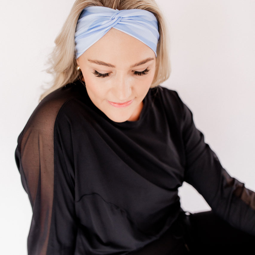 Sky Blue Flow headband with monochromatic waves and white lines, designed for versatility and comfort with a stretchy, ultra-soft fabric that's perfect for any workout or or outfit.
