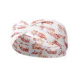 You Herd Me white headband with pink, red and orange floral cow pattern, featuring a knot design. Ultra-stretchy, non-slip poly-knit blend, perfect for workouts, long shifts, or playdays.