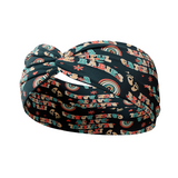 A black headband with text Beautiful Day to Catch Babies and foot prints with rainbows, flowers and hearts. Versatile, soft, non-slip, absorbent fabric for confidence and function.