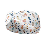 A white headband with babies in blankets pattern on it.