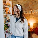 Woman confidently wearing the Hungry for Reading headband for cute hairstyles and comfortable all-day wear.