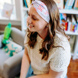 Woman confidently wearing the Lavender Library Lover headband for cute hairstyles and comfortable all-day wear.