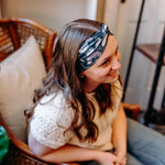 Woman confidently wearing the Lines, Vines & Felines headband for cute hairstyles and comfortable all-day wear.