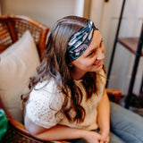 Woman confidently wearing the Lines, Vines & Felines headband for cute hairstyles and comfortable all-day wear.