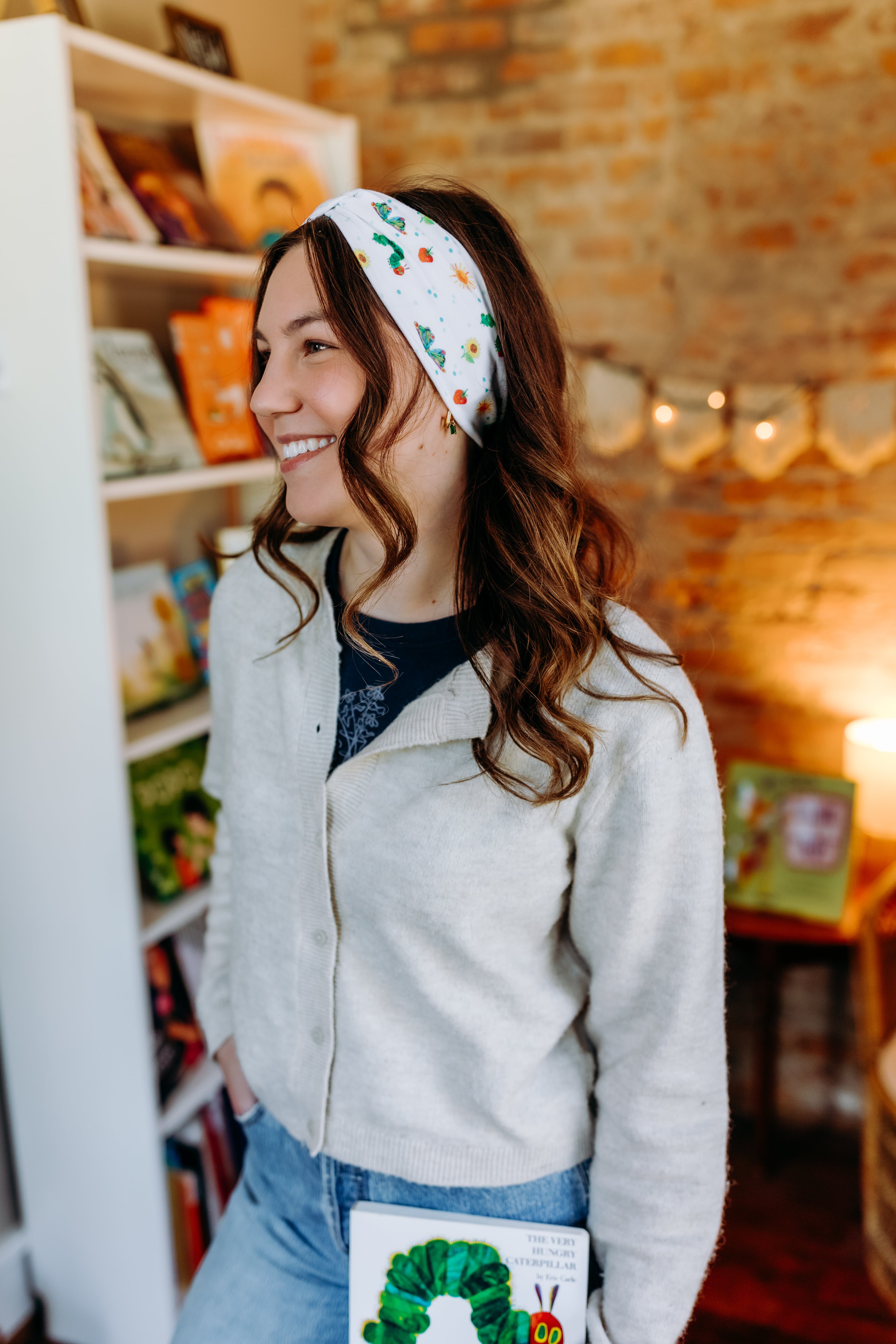 Woman confidently wearing the Hungry for Reading headband for cute hairstyles and comfortable all-day wear.