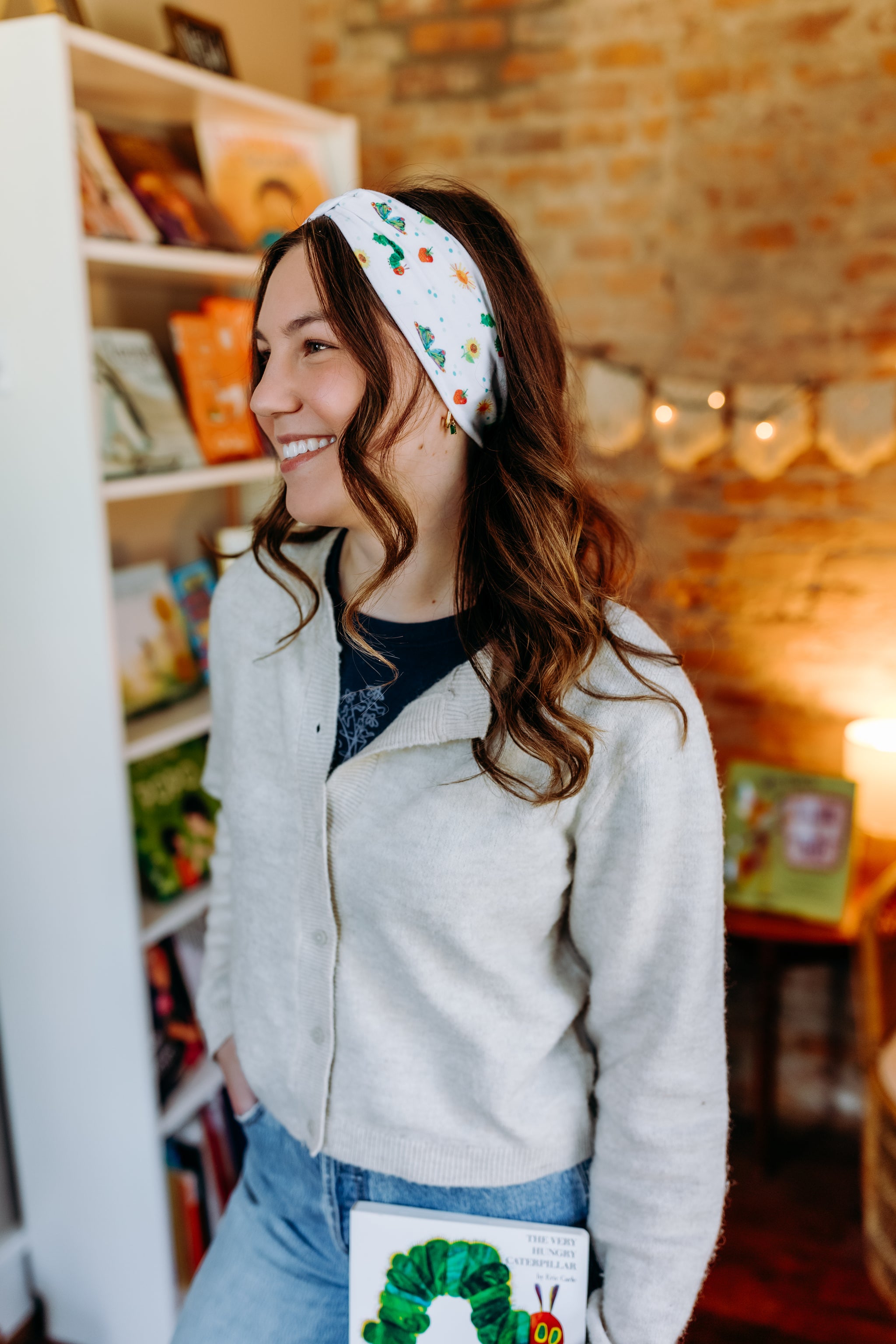 Woman confidently wearing the Hungry for Reading headband for cute hairstyles and comfortable all-day wear.