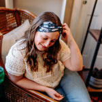 Woman confidently wearing the Lines, Vines & Felines headband for cute hairstyles and comfortable all-day wear.