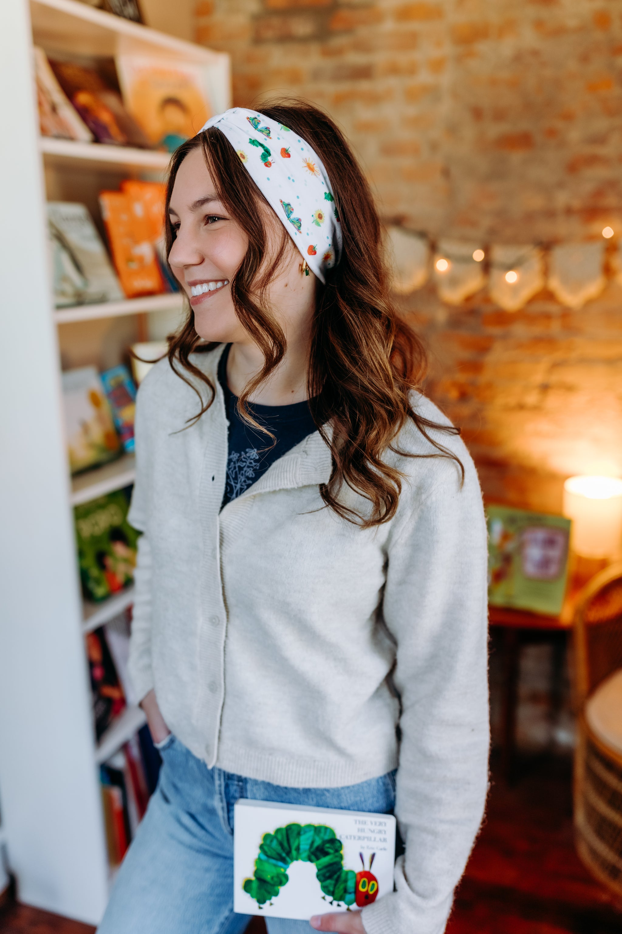 Woman confidently wearing the Hungry for Reading headband for cute hairstyles and comfortable all-day wear.