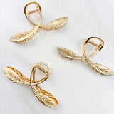 One of a Kind Lilac Clip from The Sarah Wallace collection: Gold hair clip with feather design, 4.4 inches long, hinge closure, ideal for keeping hair out of the face.