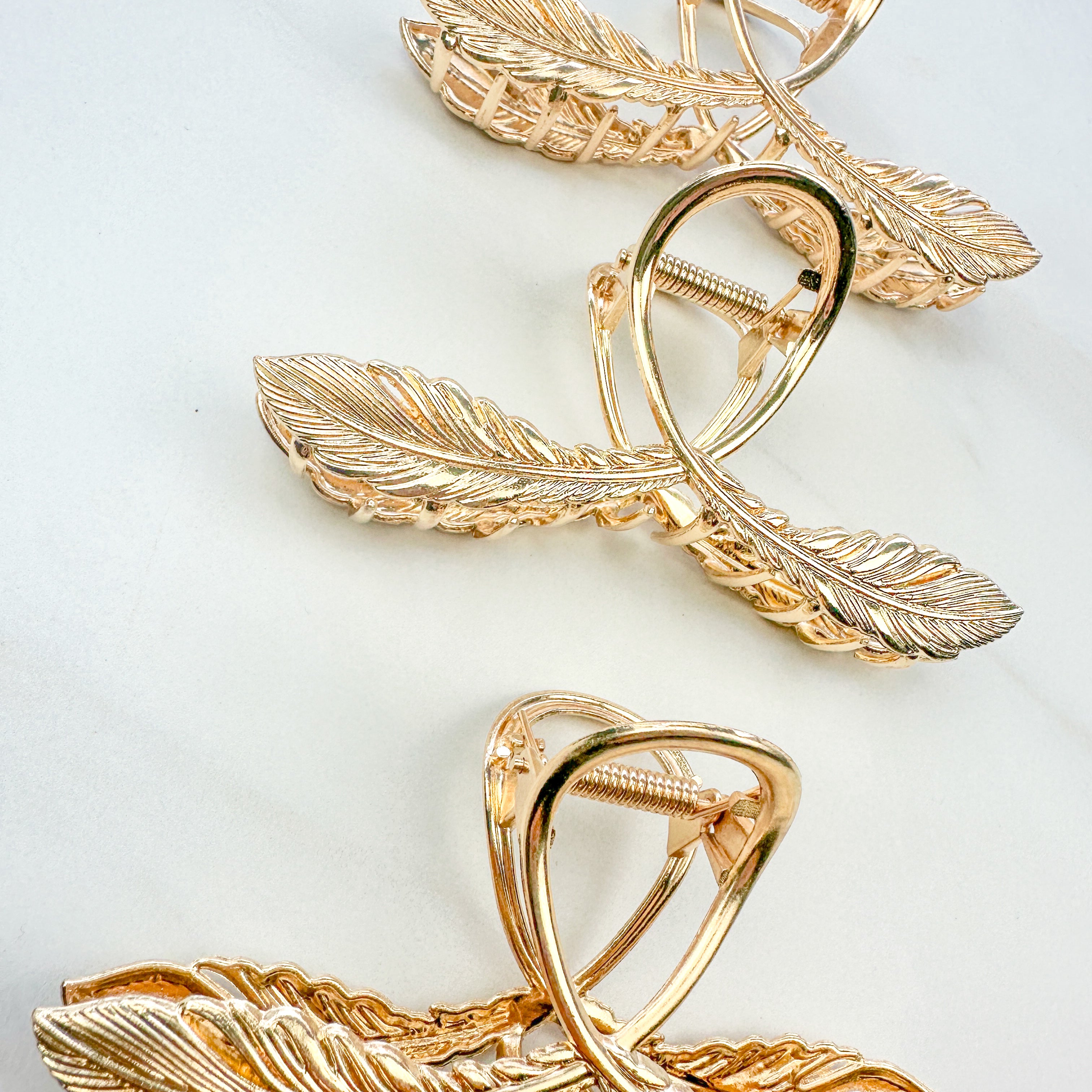 One of a Kind Lilac Clip from The Sarah Wallace collection: Gold hair clip with feather design, 4.4 inches long, hinge closure, ideal for keeping hair out of the face.