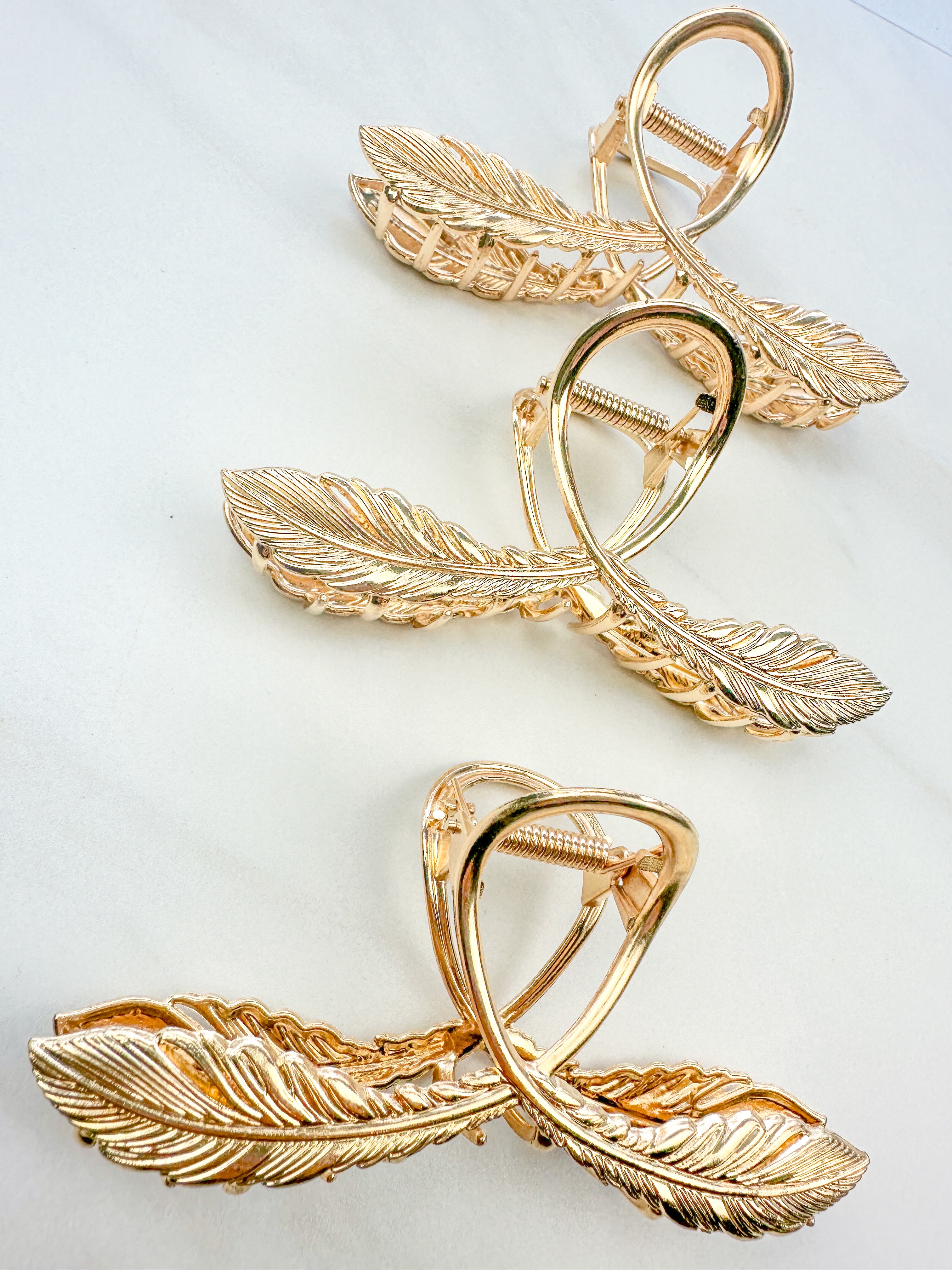 One of a Kind Lilac Clip from The Sarah Wallace collection: Gold hair clip with feather design, 4.4 inches long, hinge closure, ideal for keeping hair out of the face.