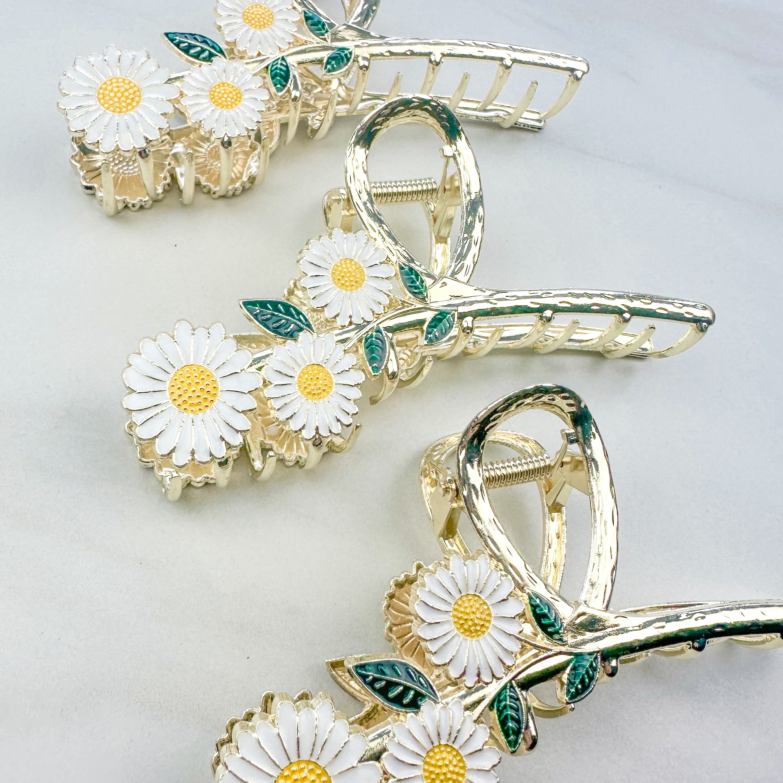 Grow With Grace Clip featuring a three white daisy flowers on a metal hair clip with hinge closure, part of The Sarah Wallace Collection.