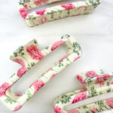 No Rain, No Flowers Clip featuring a pink peony floral design, glossy material, and hinge closure from The Sarah Wallace Collection.