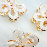 Central Park Stroll Clip: A close-up of a marble and metal hair claw clip, 2.75 inches long, featuring a hinge closure, ideal for keeping hair out of your face.