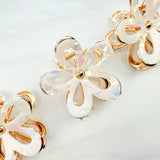 Central Park Stroll Clip: A close-up of a marble and metal hair claw clip, 2.75 inches long, featuring a hinge closure, ideal for keeping hair out of your face.