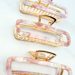Pink Break A Leg Clip from The Sarah Wallace Collection, featuring a marble and metal design with a hinge closure.