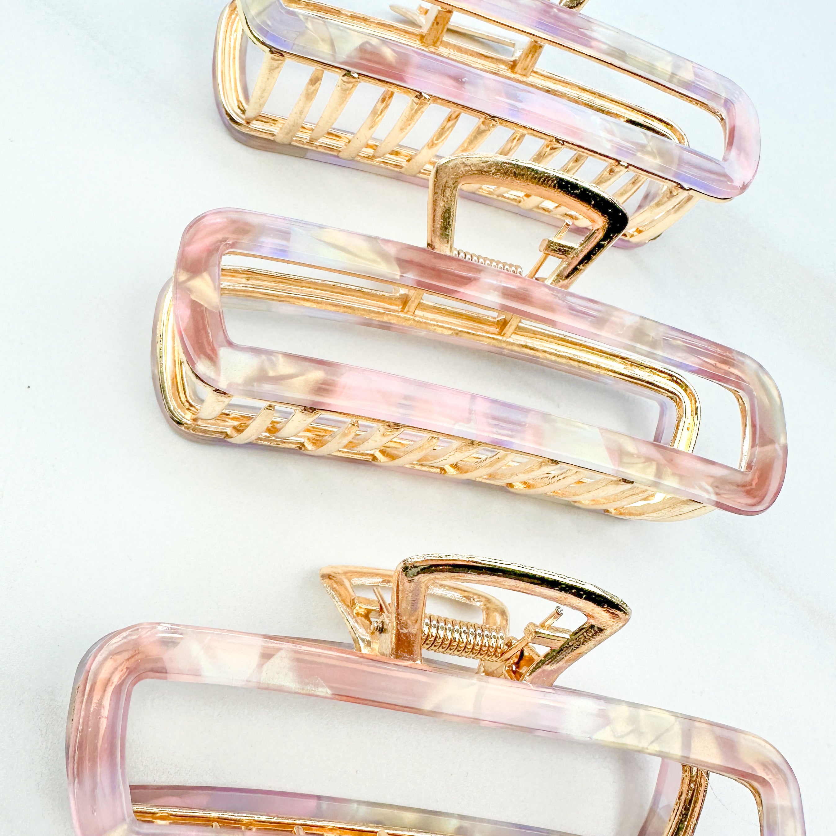 Pink Break A Leg Clip from The Sarah Wallace Collection, featuring a marble and metal design with a hinge closure.