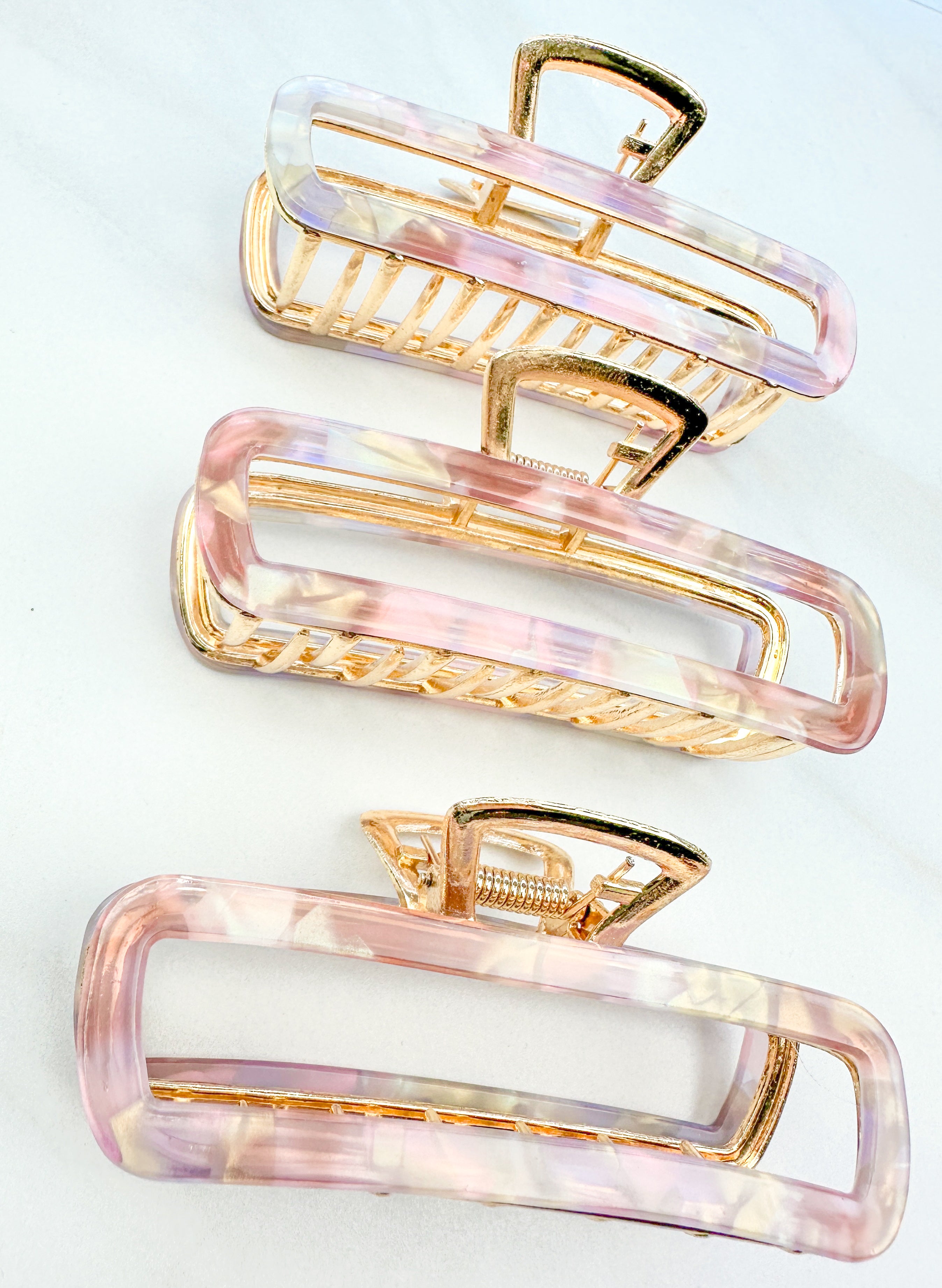 Pink Break A Leg Clip from The Sarah Wallace Collection, featuring a marble and metal design with a hinge closure.