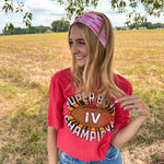 Woman confidently wearing On Sunday's We Wear Pink headband, smiling outdoors. The headband is functional, ultra-stretchy, and perfect for workouts or casual wear.