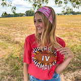 Woman confidently wearing On Sunday's We Wear Pink headband, smiling outdoors. The headband is functional, ultra-stretchy, and perfect for workouts or casual wear.