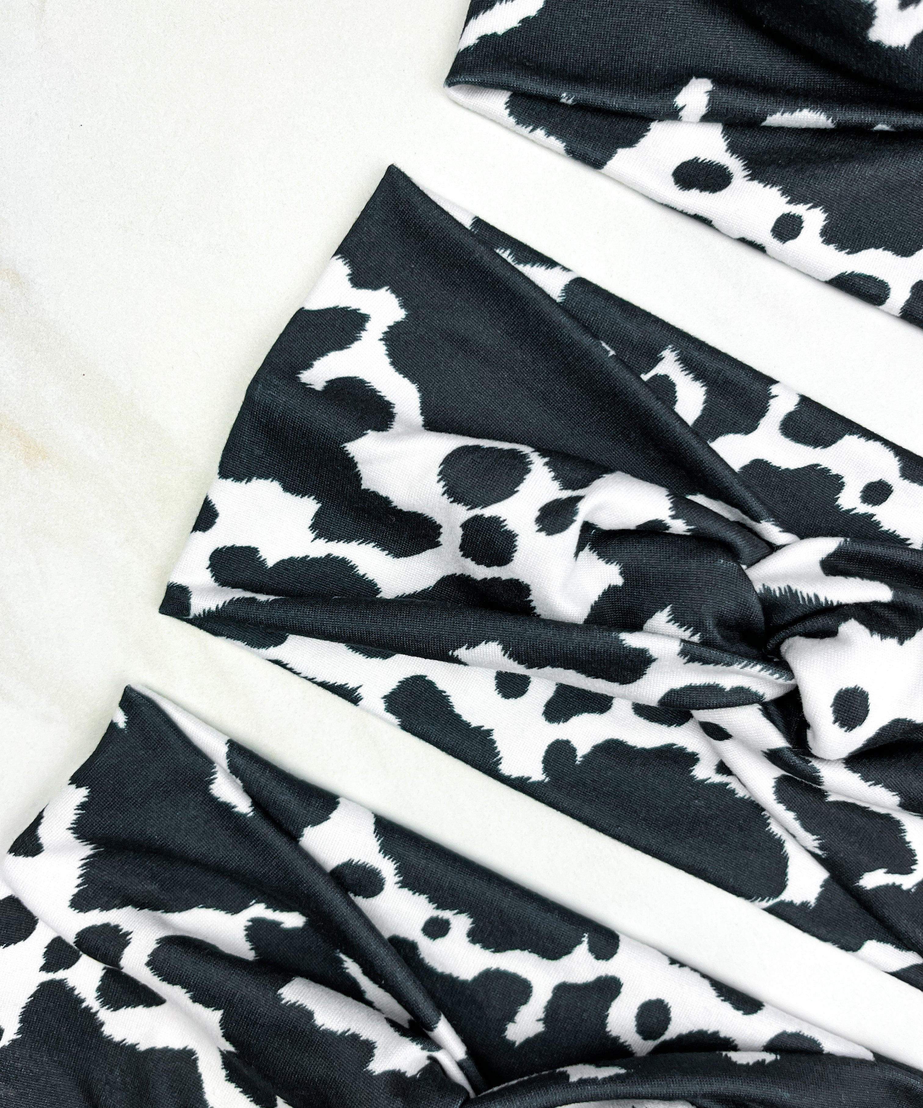 Adult women's white headband with black cow spot print