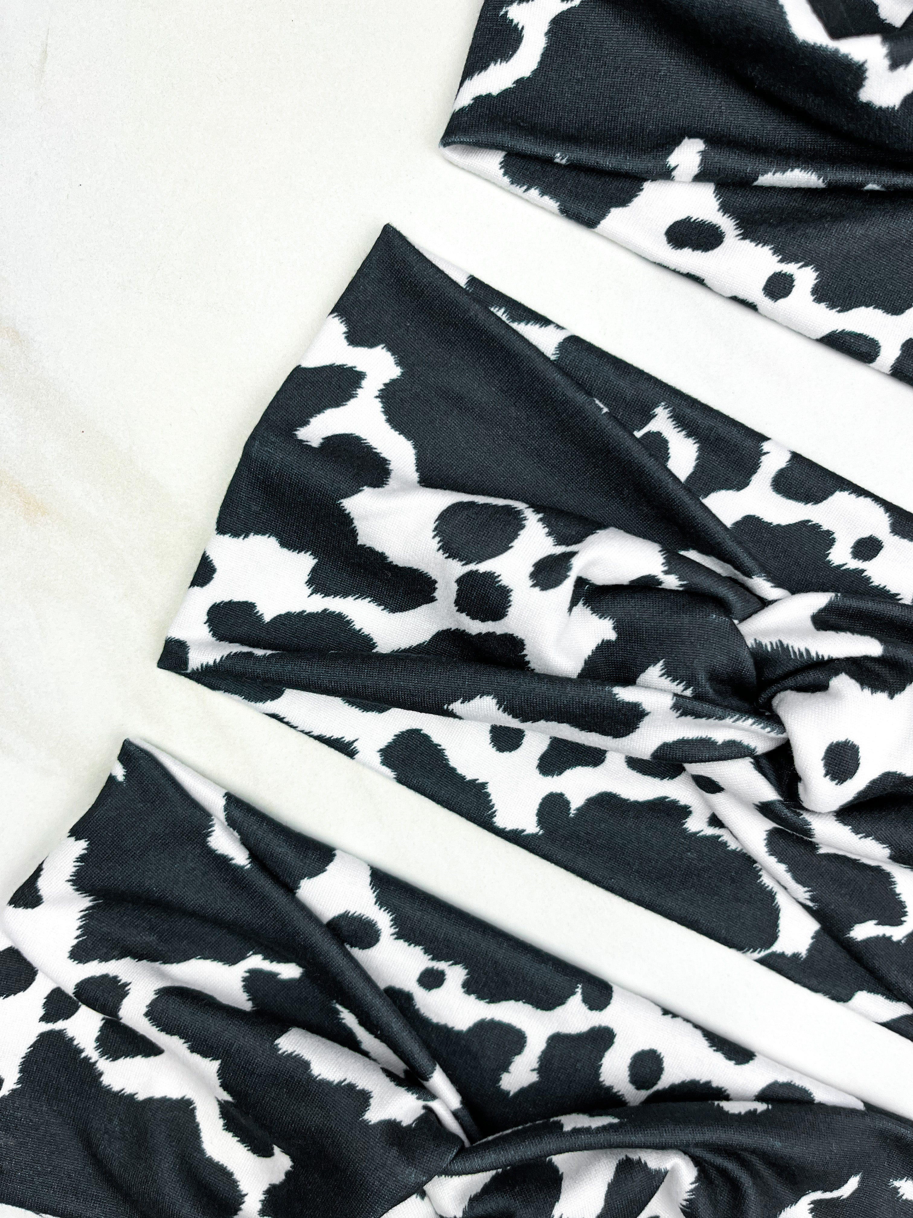 Adult women's white headband with black cow spot print